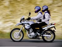 Rider with passenger on a BMW F650 traveling on an Alpine Adventure
