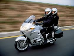 Rider with passenger on a BMW R1200RT traveling on an Alpine Adventure